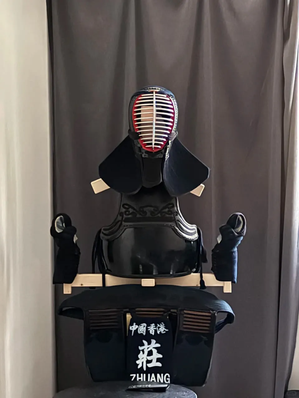 Kendo bogu displayed on a wooden stand